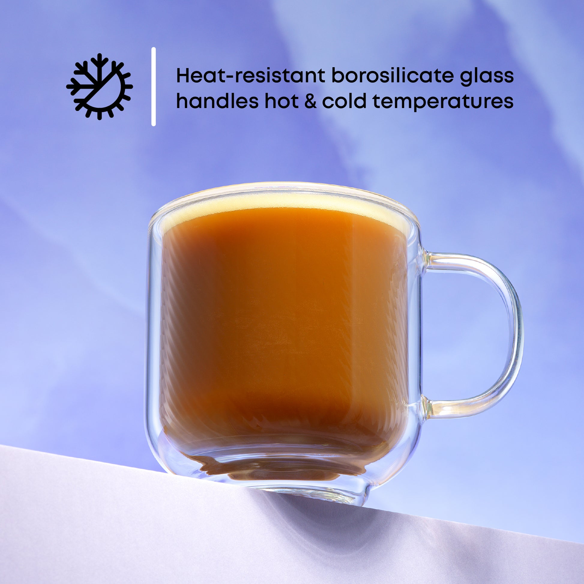 Glass mug with hot beverage on a light background, featuring text about heat-resistant borosilicate glass.