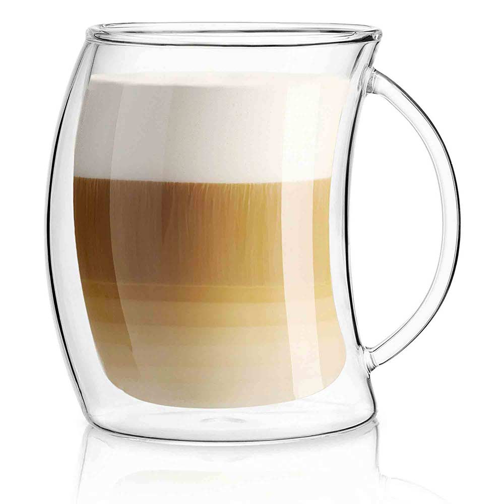 A double wall glass mug with handle filled with a layered coffee drink on a white background.